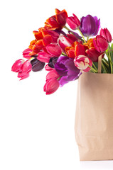 Paper shopping bag with colorful tulips in spring