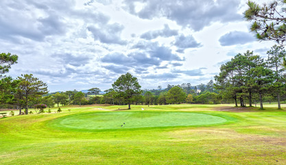 Centre hole golf course on Da lat hills to green grass beautifully decorated pine forests interspersed create fresh beauty attracts tourists to this resort in Lam Dong, Vietnam