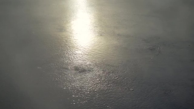 Natural Onsen Hot Spring Close Up Boiling Water Steam and Sunset.