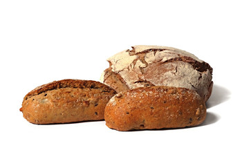 three rustical country style breads with seeds on white background