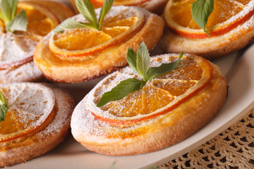 Almond cookies with oranges mint macro on a plate. horizontal
