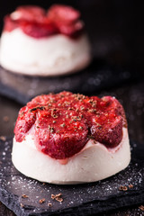 cheese dessert with strawberry on black background