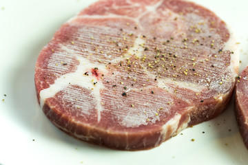 close up Fresh raw beef steak isolated on white plate