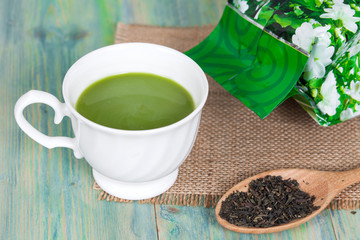 green tea with milk or hot matcha latte on wood