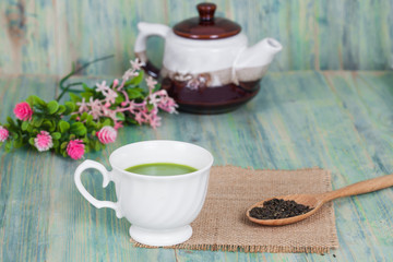 green tea with milk or hot matcha latte on wood
