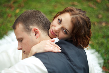 Fototapeta premium A beloved one - bride press a groom's head to her shoulder
