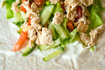 Boiled chicken breast with fresh vegetables and sour cream