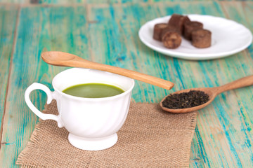green tea with milk or hot matcha latte on wood