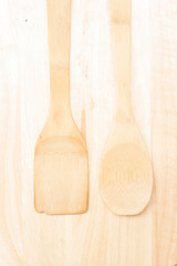 various wood made kitchen tools on a natural wood background