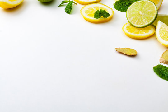 Pieces of lemon and lime on a white background.