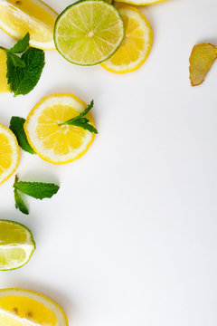 Pieces of lemon and lime on a white background.