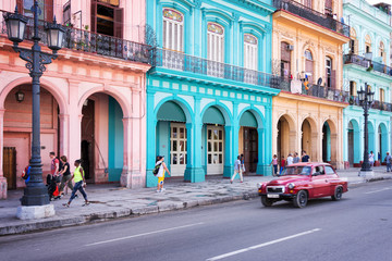 HAVANA, CUBA - APRIL 18: Classic vintage car and colorful colonial buildings in the main street of Old Havana, on April 18, 2016 in Havana