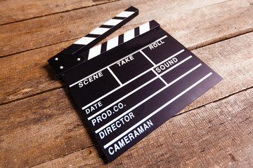 photo of movie clapper on wood