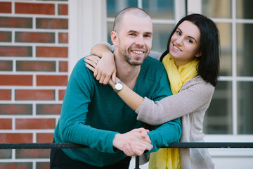 Fototapeta premium Cheerful young couple standing in front of new house look at the camera moving purchase of new habitation