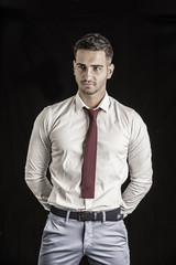 Young smiling man in white shirt and red tie