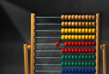 Colorful Wooden Abacus on a Blackboard