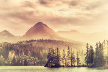 Vintage Sunset over a Lake in Mountains © firewings