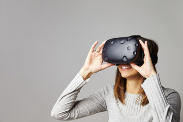 Young Woman Wearing Virtual Reality Headset In Studio
