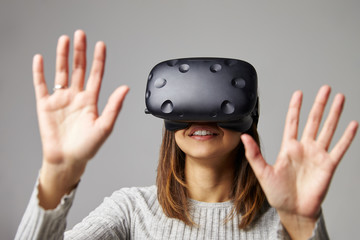Young Woman Wearing Virtual Reality Headset In Studio