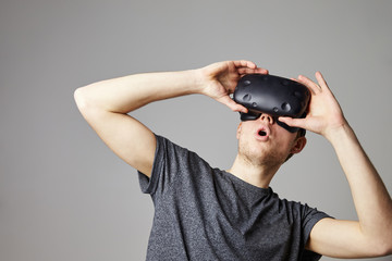 Young Man Wearing Virtual Reality Headset In Studio