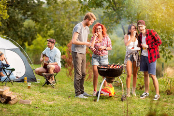 Guys and lassies feed each other with skewers - obrazy, fototapety, plakaty