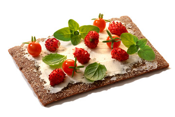 Bread crisp with fresh strawberries, soft cheese and mint