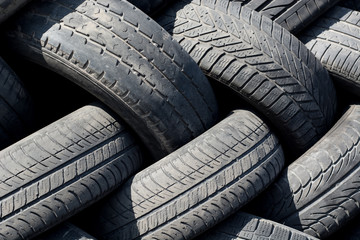 Old used car tires on heap