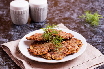 Delicious potato pancakes on plate with dill