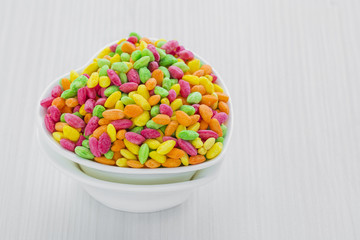Colorful Rice Cereal on the pink dishcloth with glass of water a