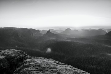 Misty awakening in beautiful mountains park. Peaks of hills
