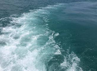Speed boats trace tail on the blue sea