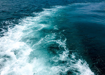 Speed boats trace tail on the blue sea