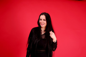 Full body of a beautiful woman wearing red dress on black background