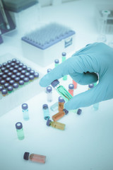 scientist holding test tube vaccine in medical laboratory