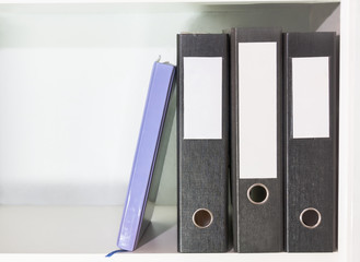 Folders for documents and planner on a book shelf