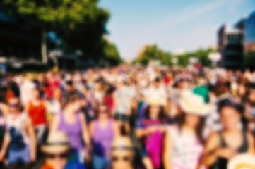 defocused background of people partying or marching outdoors - obrazy, fototapety, plakaty