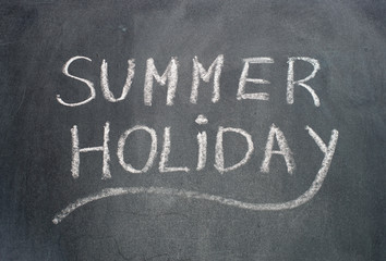 Summer holiday text on blackboard.