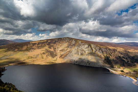 Wonderful view of mountains, lake and dramatic sky with clouds. Wicklow Ireland.
