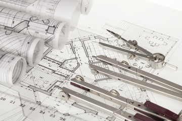 rolls of architecture blueprints, house plans &  compasses