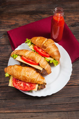 vegetarian croissant cheese breakfast on wood background