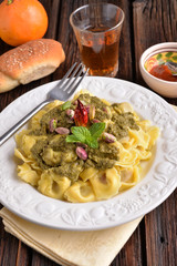 Cappelletti pasta with pistachio and red pepper on the table