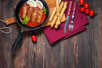 Homemade meat roll on iron pan. Style rustic