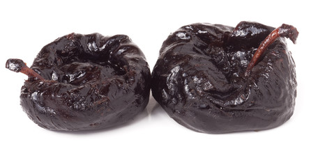 two dried prunes isolated on a white background closeup macro