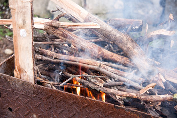 Wood burning in a barbeque grill. Closeup of firewood 