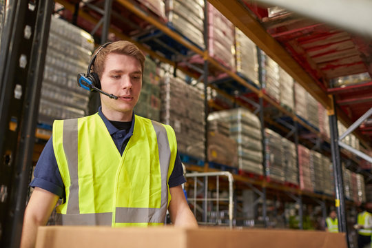 Man wearing a headset working in a distribution warehouse