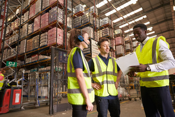 Distribution warehouse manager instructing colleagues