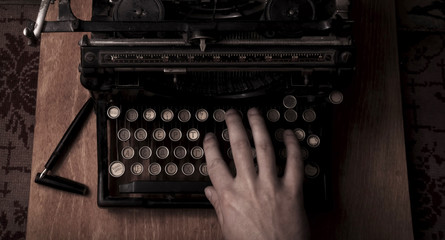Man typing on an old typewriter, with a retro effect
