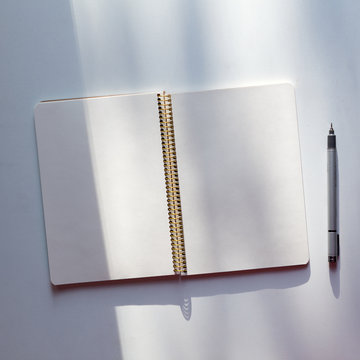 Notepad and pen on table