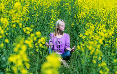 Fototapeta premium The girl meditates in a grass.
