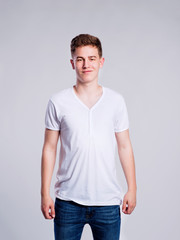 Boy in jeans and t-shirt, young man, studio shot